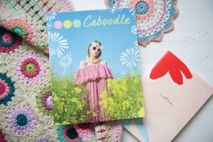 Caboodle Magazine flatlay of front cover with crochet and notebook
