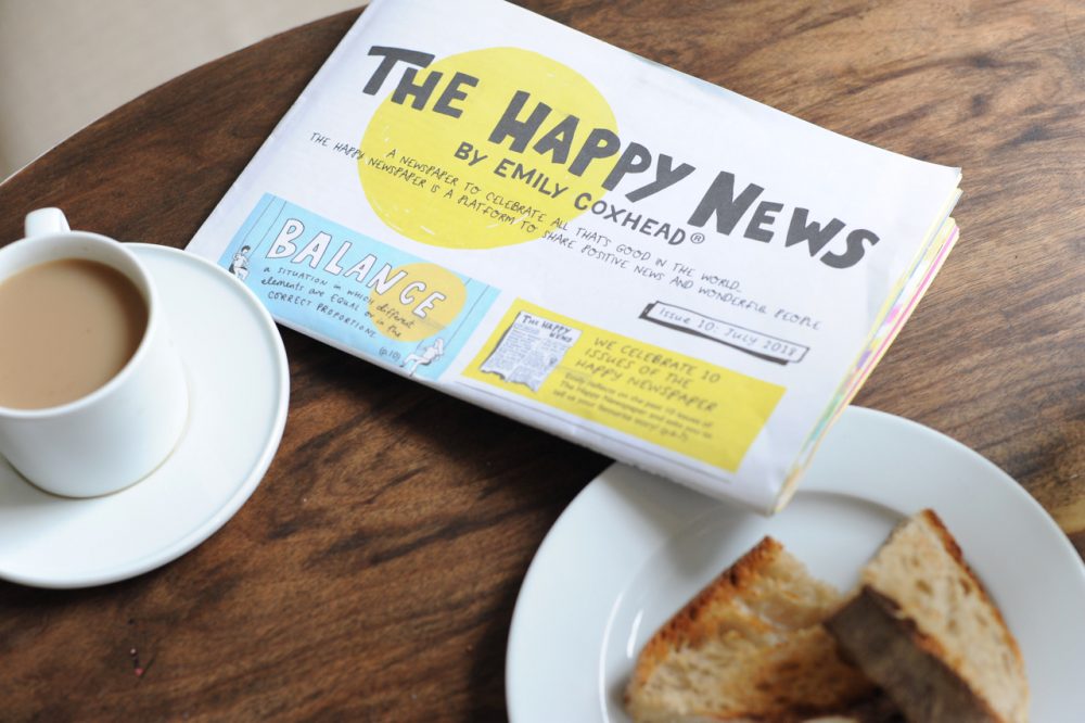 The Happy Newspaper with tea and toast